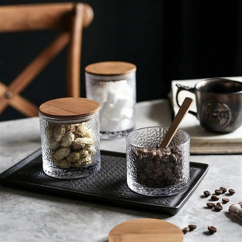 Top Shelf Airtight Glass Storage Jars 320 Milliliters With Durable Sealed Lids for coffee beans and snacks on a kitchen countertop.