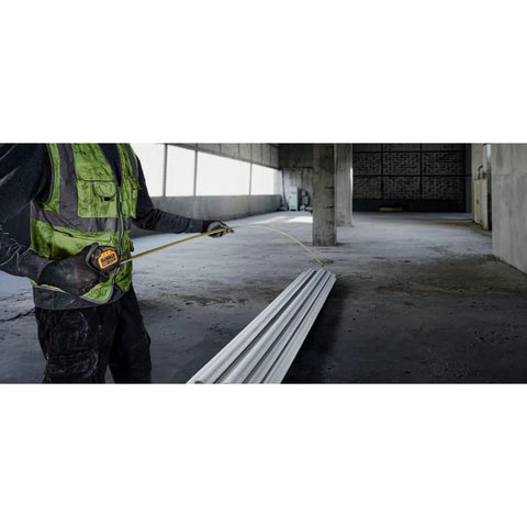Builder using Tough Series 25 Ft Tape Measure With Magnetic Clip And Double Sided Blade Pro Grade Heavy Duty in a construction site