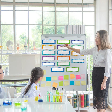 Teacher using Neon Magnetic Name Labels Set 50 Pcs 6 By 2 Inches Reusable Magnetic Dry Erase Tags on whiteboard in classroom.