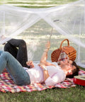Couple relaxing under Four Corner Bed Mosquito Net For Canopies And Travel, Rectangular Mesh Netting With High Density Breathable Fabric