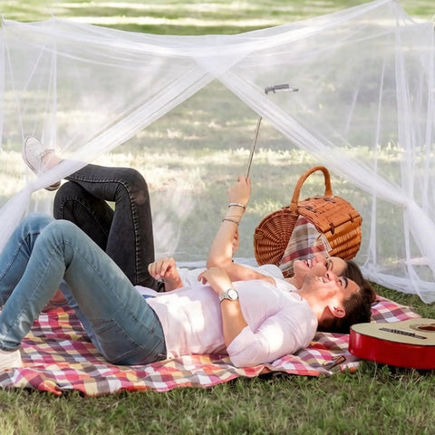 Couple relaxing under Four Corner Bed Mosquito Net For Canopies And Travel, Rectangular Mesh Netting With High Density Breathable Fabric