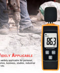 Portable Handheld Sound Level Meter For Indoor And Outdoor Noise Testing, 30 To 130 dB, Backlit LCD Display, Max Min Hold Functions, The No Nonsense Practical Little Tool For Noise Pollution Monitoring And Home Theater Setup. Orange handheld sound meter showing 86.3 dBA at a demolition site.