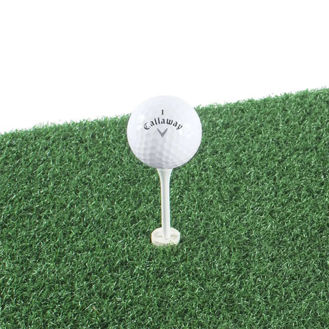 Golf ball on tee on backyard golf hitting and putting mat with durable rubber backing for real course feel 1 by 2 foot green turf.