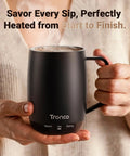 No App Hassle Self Heating Coffee Mug With Precise Temperature Control, 14 Oz Travel Cup in black held by a person.