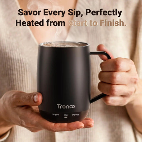No App Hassle Self Heating Coffee Mug With Precise Temperature Control, 14 Oz Travel Cup in black held by a person.
