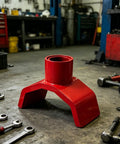 Beefy Bottle Jack Adapter Lifting Saddle For 2 To 4 Inch Axle Tubes, heavy duty steel in a garage setting with tools.