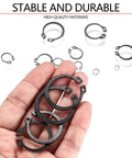 Hand holding carbon steel snap rings from 550 Piece Snap Ring Set For Axles And Shafts External Circlip Retaining Clips