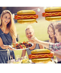 Group enjoying BBQ with Six Pack Hot Dog Balloons Set For Food Theme Parties, Summer BBQs And Picnic Decor visible in background.