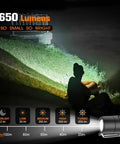 Rechargeable Keychain Flashlight 650 Lumens EDC Pocket Light illuminating outdoor area at night