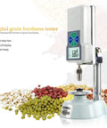 Handheld Digital Hardness Tester And Sclerometer For Corn Wheat Coffee And Feed Dead On Accuracy With Easy Grip Body, displaying grains.