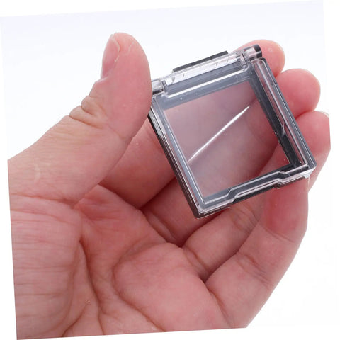 Close-up of a hand holding a 26mm Button Switch Dustproof Cover with Double-Sided Adhesive, clear plastic design for PC and appliances.