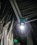 LED lantern flashlight illuminating workspace with cables, part of Solid Build 7 2 Volt Cordless Hex Driver Drill With Auto Stop Clutch And Dual Speed Settings Paired With A Versatile Led Lantern Flashlight Bundle For No Sweat DIY Grind And Quick Fixes.