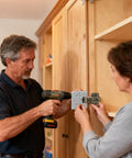 Man using Door Hinge Router Jig With Adjustable Mortise Guide And 2mm Precision Groove on a wooden cabinet door