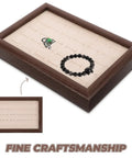 Solid Wood Earring Organizer And Ring Keeper Tray With Thirty Open Slots For Stashing Bracelets And Chains In A Rich Walnut Finish, showing black bracelet and green stone.