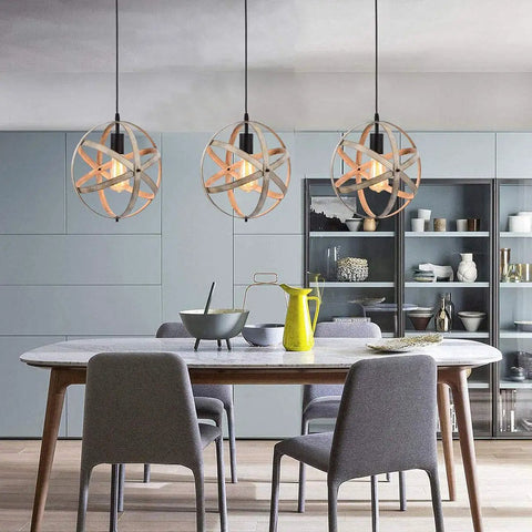 Dining room with three Industrial Spherical Pendant Light With Changeable Cage Design Plug In 15 Ft Cord And On Off Switch Vintage Metal Fixture hanging over a table.