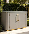 Outdoor storage cabinet with satin brass hardware, surrounded by greenery, showcasing Built Tough 4 Pack Heavy Duty Satin Brass Hinges In Stainless Steel Four Inch Size Satin Gold Finish For Exterior Wood Doors Shutters Security Gates And Outdoor Storage Includes Seven Exact Hole Size Options For A Precise Fit.
