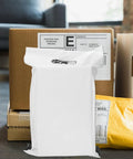 White poly mailer bag with adhesive seal standing among boxes, representing 100 Pack White Poly Mailer Bags Thickened Lightweight Envelopes.