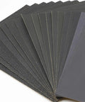 Top Tier Wet Dry Sandpaper Set Ranging From 60 To 20,000 Grit With Silicon Carbide Sheets stacked for car polishing and woodworking.