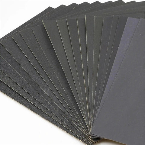 Top Tier Wet Dry Sandpaper Set Ranging From 60 To 20,000 Grit With Silicon Carbide Sheets stacked for car polishing and woodworking.