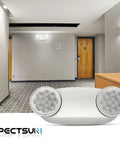 12 Pack LED Emergency Light Fixtures Boasting Rock Solid Battery Backup And Iconic Bug Eye Lenses in a modern hallway setting.
