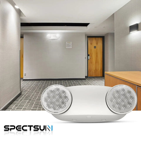 12 Pack LED Emergency Light Fixtures Boasting Rock Solid Battery Backup And Iconic Bug Eye Lenses in a modern hallway setting.