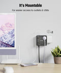 12 In 1 Power Strip With USB Ports For Home Office Dorm Travel And More, mounted on wall next to monitor and plant