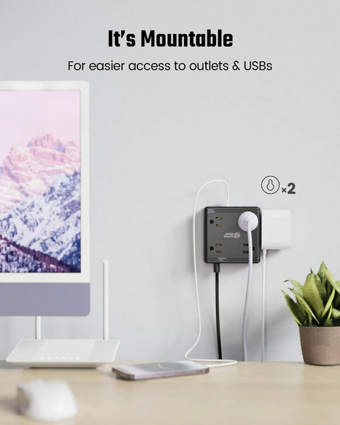 12 In 1 Power Strip With USB Ports For Home Office Dorm Travel And More, mounted on wall next to monitor and plant