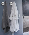 304 Stainless Steel Towel Hooks And Robe Hooks Wall Mounted With Brushed Nickel Finish holding a towel and robe in a bathroom.