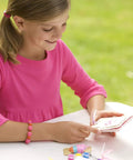 Girl using Green Creativity Pressed Flower Art Kit With Recycled Flowers, DIY Crafts For Kids Ages 5 And Up outdoors