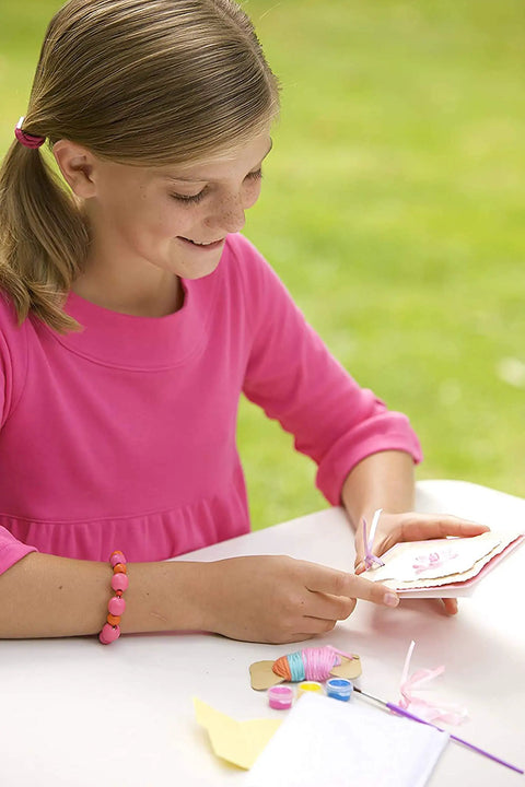 Girl using Green Creativity Pressed Flower Art Kit With Recycled Flowers, DIY Crafts For Kids Ages 5 And Up outdoors