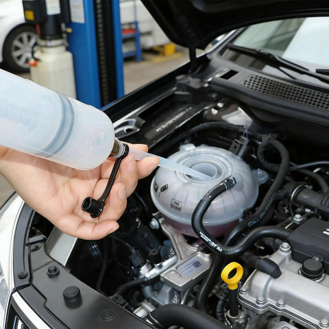 Ultimate 200Cc Fluid Extractor Pump For Oil Gas Power Steering Brake And Transmission draining fluid from an engine tank.