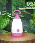 Kid Friendly Camping Lantern And Night Light With AAA Batteries Included, 360 Degree Eye Safe Glow, IPX4 Waterproof on tree stump
