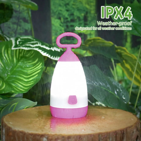 Kid Friendly Camping Lantern And Night Light With AAA Batteries Included, 360 Degree Eye Safe Glow, IPX4 Waterproof on tree stump