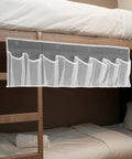 Compact Mesh Shoe Storage Hangs Beside Bed With 4 Hooks For RV Camper And Home to stash sneakers and boots in gray fabric.