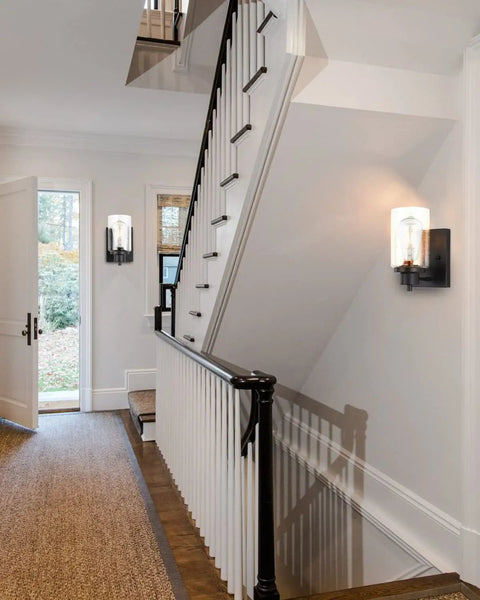 2-Pack Dope Modern Bath Vanity Light Fixtures With Seeded Glass Sconces illuminating a hallway with black railing and carpet