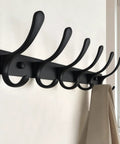 Wall Mounted Coat Rack With Six Heavy Duty Hooks Stainless Steel Metal Hanger Sturdy Coat Rack For Coats Jackets Hats Bags Space Saving Black Finish For Small Spaces In Any Room shown mounted on a wall with beige coat hanging.