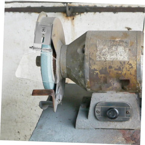 Bench grinder with two piece stainless steel bench shield kit eye guard for grinders, rust resistant eyeshield visible in workshop.