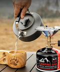 Isobutane Camping Stove Fuel Canister 230 Gram Butane Propane Blend Fuel with kettle pouring water in wooden cup