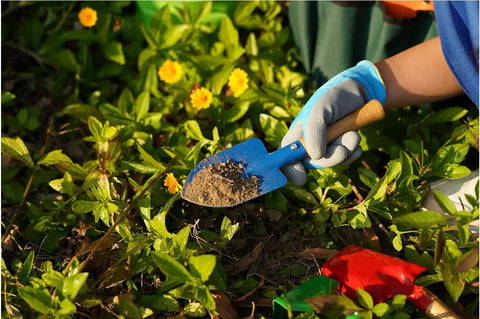 Child using Kids Metal Garden Tool Set For Little Green Thumbs With Real Shovel on plants