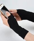Breathable Wrist And Thumb Compression Gloves With Soft Gel Pads For Tendonitis Arthritis And Carpal Tunnel Relief For Hand And Wrist Pain All Day Comfort One Pair being worn while using a smartphone