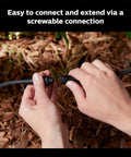 Hands connecting the Outdoor 8 Foot Low Voltage Light Cable With T Connector For Easy Landscape Lighting Setup, Weatherproof