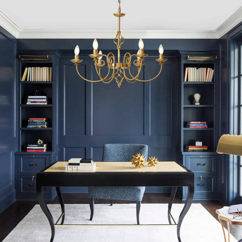 Gold Farmhouse Chandelier With Six Candle Style Lights in office setting, 26-Inch Antique Brass Finish hanging above desk