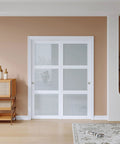60x80 Inch Bypass Sliding Closet Door For Bedroom With Double 31 Inch Panels 3 Lite Frosted Glass Sliding Door Hardware Track Kit And Floor Guide Preassembled MDF White Pocket Doors installed in room