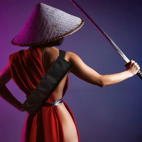 Person holding sword with Two Piece Black Katana Sword Bag Kit With Back Strap And Waistband, Ninja Carry Case visible on back.
