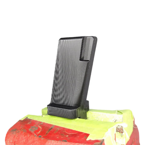 3D Printed Vise Block Gunsmith Armorer Tool For Pistols, Custom Fit Mag Well Sizes For 1911 9mm 10mm And 45 Cal Handguns, Pro Grade Clamp Block For Safe Quick Precise Maintenance. Black 3D-printed pistol vise block clamped in a red vise