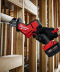 M18 Fuel One Handed Reciprocating Saw Kit cutting through PVC pipe with ergonomic grip and XC5.0 battery for home renovations.