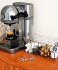 Clear Acrylic 4 Compartment Coffee Capsule Holder With Lid K Cup Organizer next to espresso machine on wooden counter
