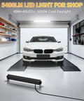 40W LED Shop Lights With 6 Foot Cord And Easy Switch 5400 Lumens Daylight 6000K Crankin Bright Plug In Garage Light For Garage Workbench And Warehouse Energy Saving Up To 80 Percent Wide 120 Degree Beam 2 Pack illuminating a garage with a car inside.