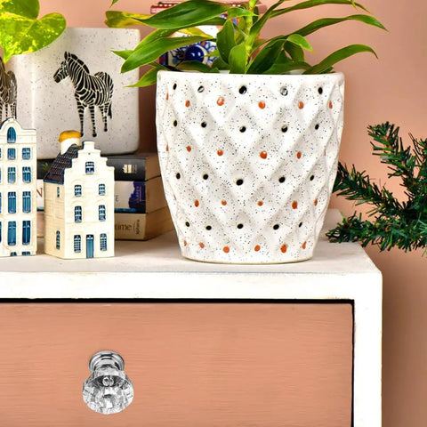 Crystal Acrylic Cabinet Knobs With Silver Base on drawer, with decorative plants and figurines, chic shine for cabinets and drawers.