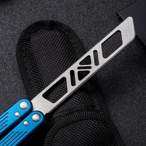 Close-up of Integrated Forging Bushing System Flip Knife with T6061 Channel Handle, blue grip detail and cutout design, in open position.